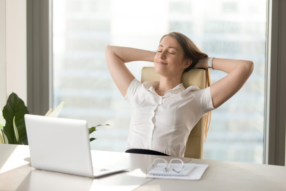 A person sitting back in a chair because they are stress-free