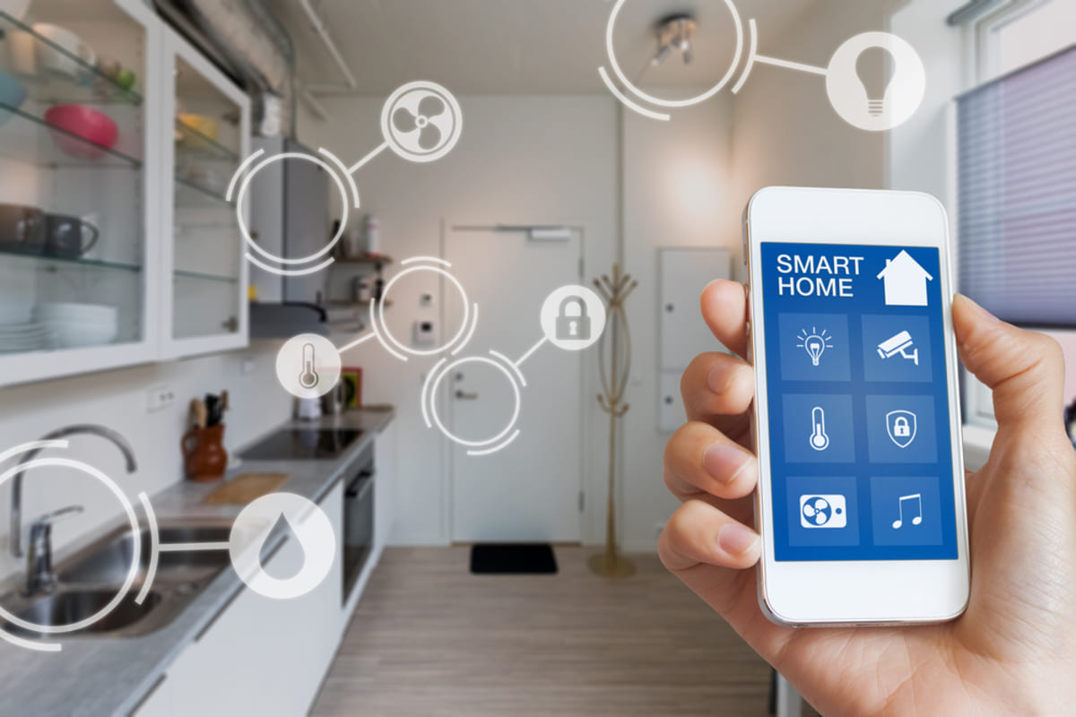 Someone holding a phone to control their smart home