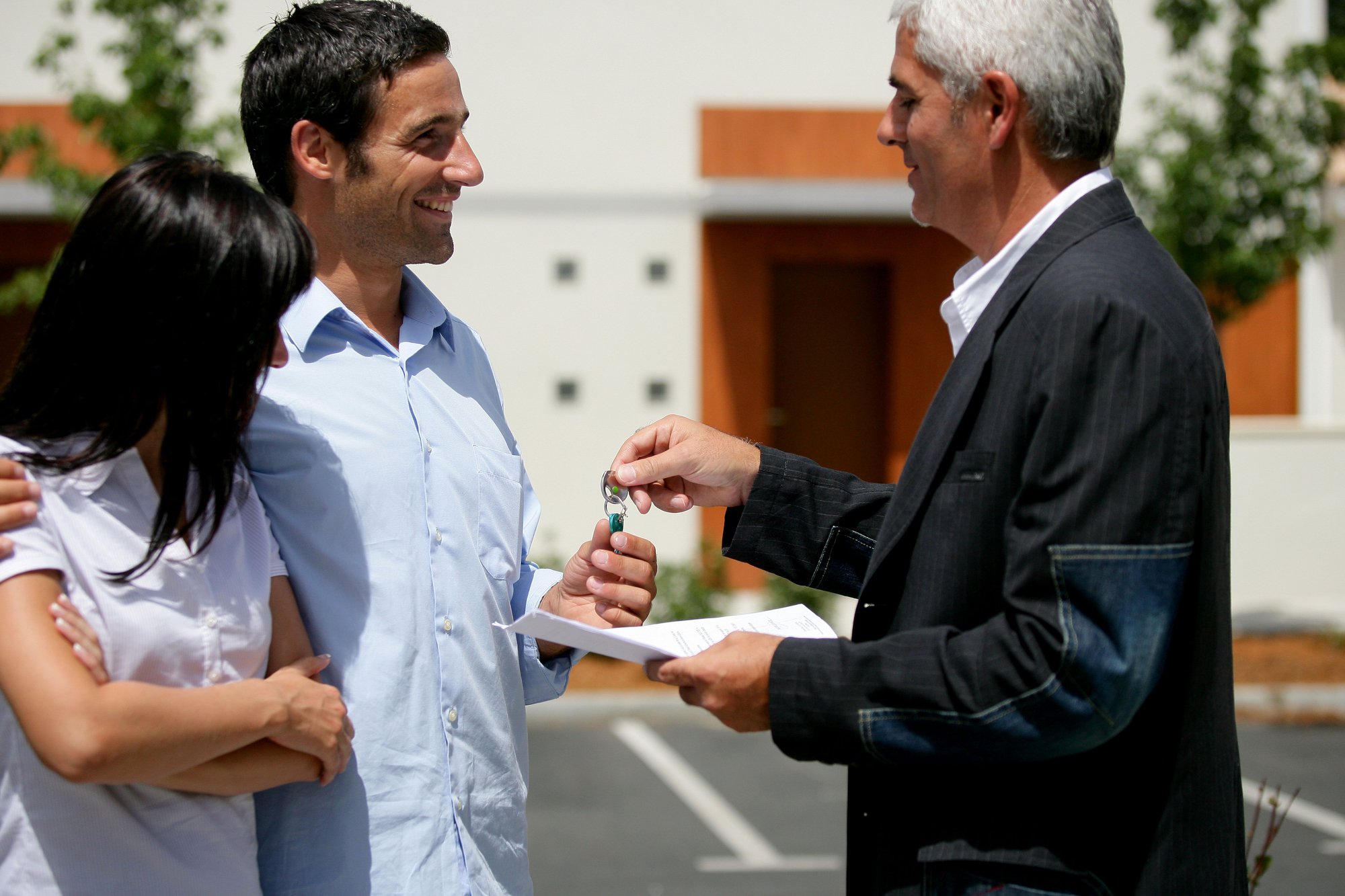 Couple receiving the keys to their new apartment