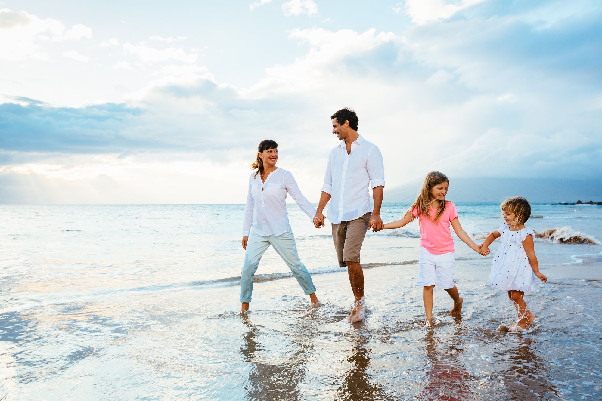 Happy Family have Fun Walking on Beach at Sunset