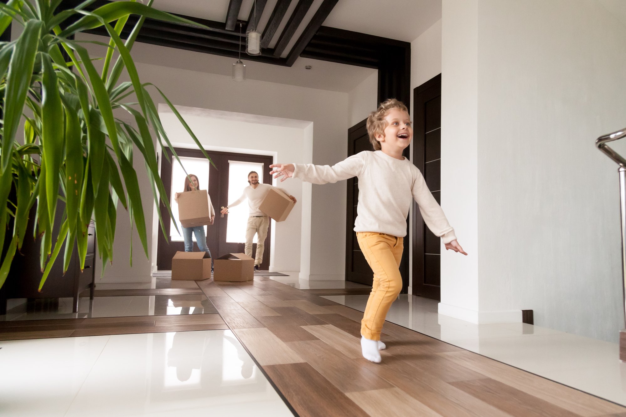 Happy family with little son arrived at their new house