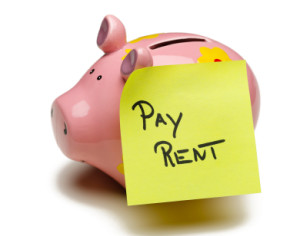 pay rent sticky note on piggy bank