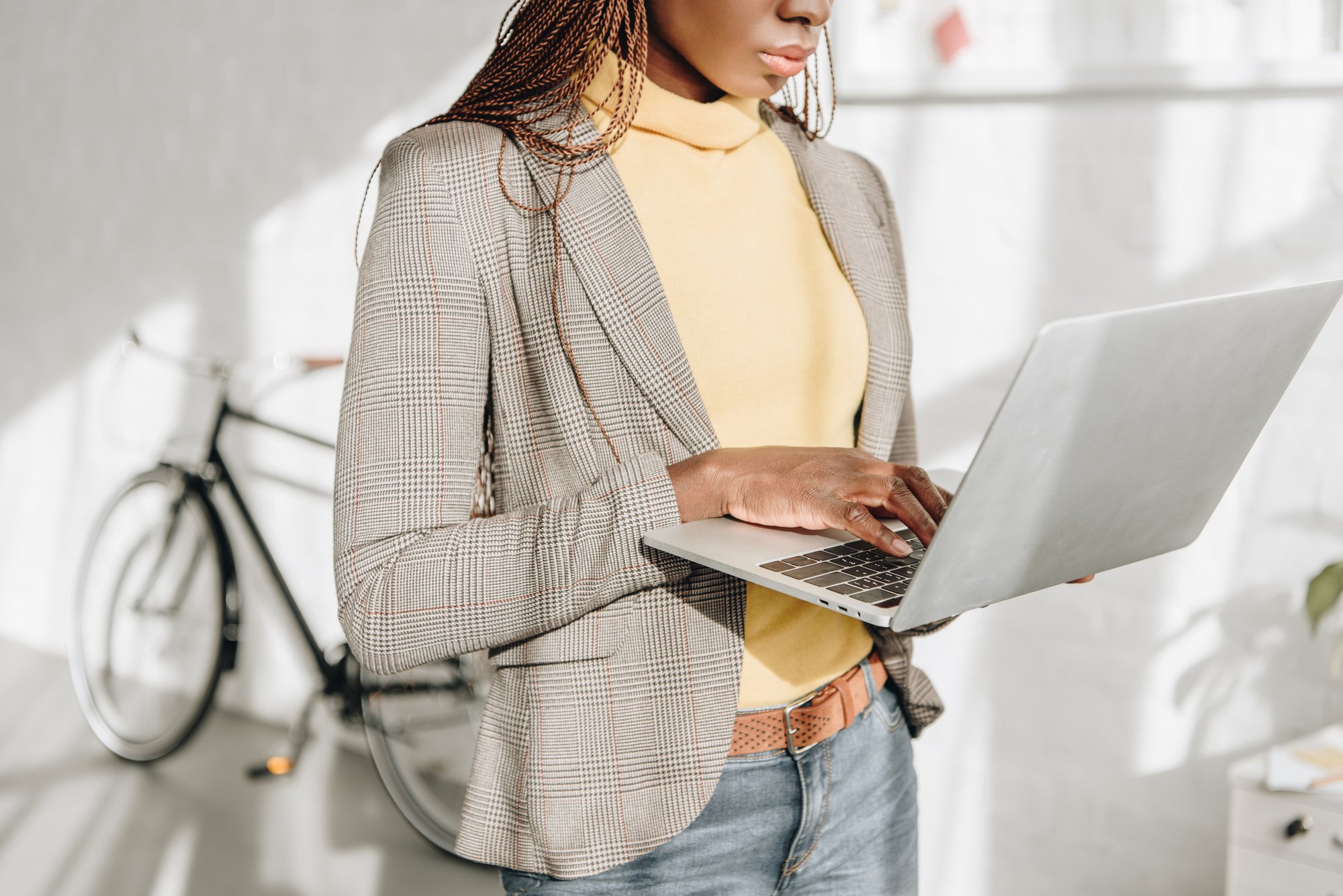 Midsection of african american adult businesswoman using laptop