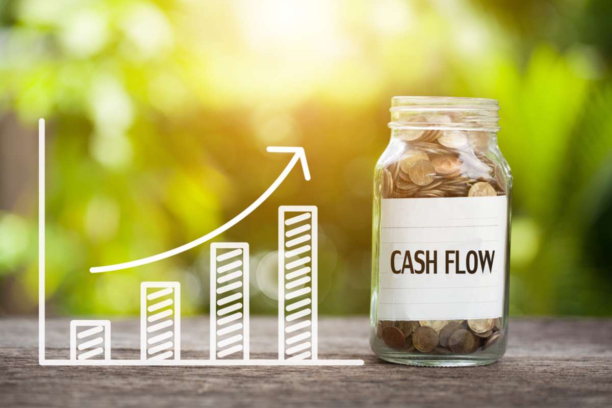 Cash Flow Word With Coin In Glass Jar and graph up