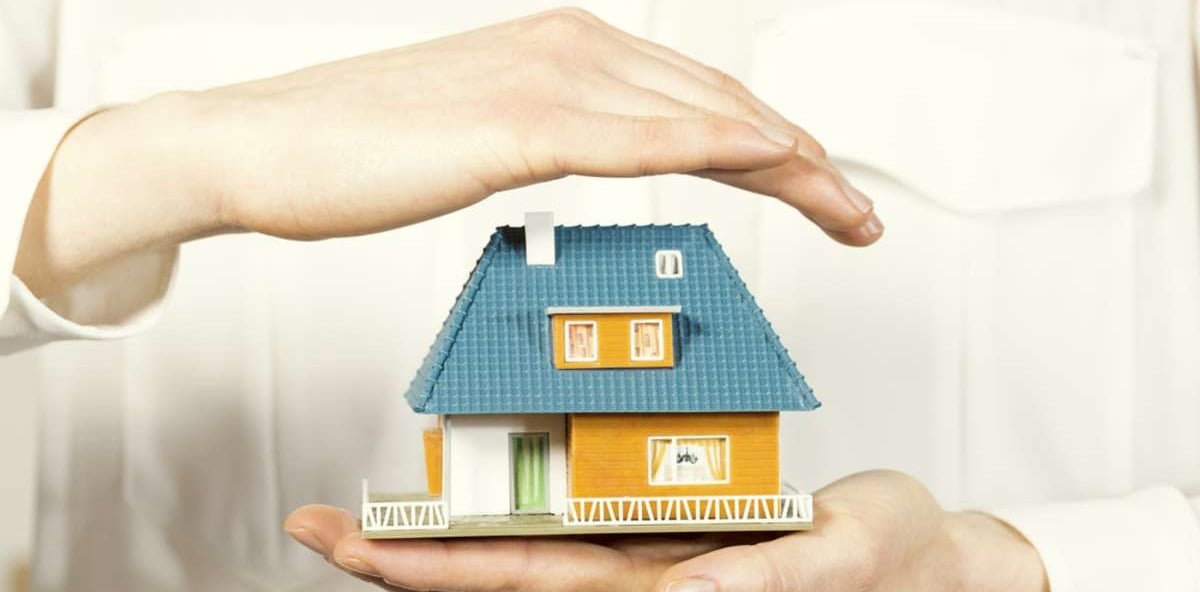 hand hovering small family house, home insurance concept 3-1