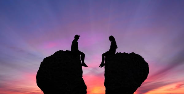 Young Couple in Quarrel Sitting on Rocks