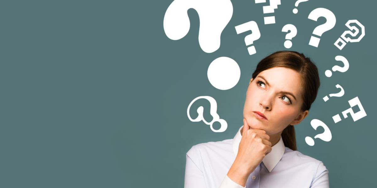 Young woman with question marks