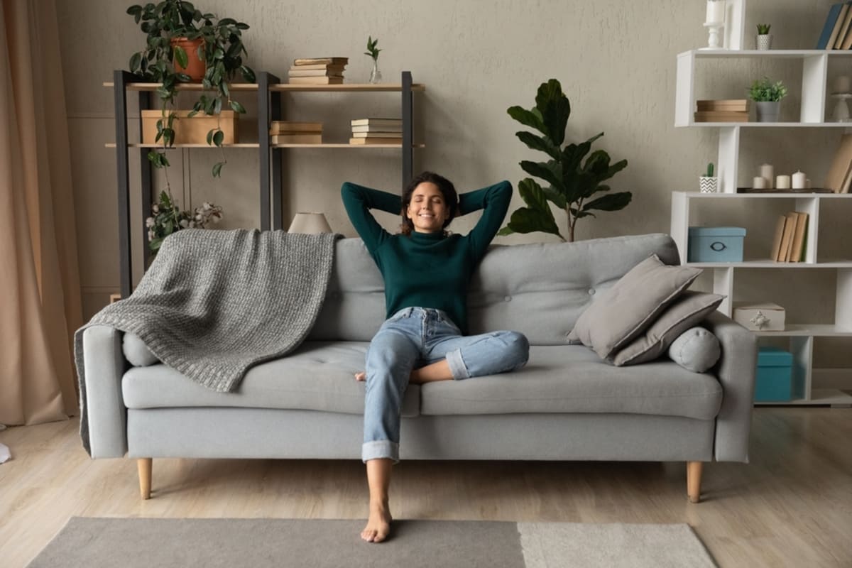 A happy tenant relaxing in their home, tenant retention strategies - featured_image