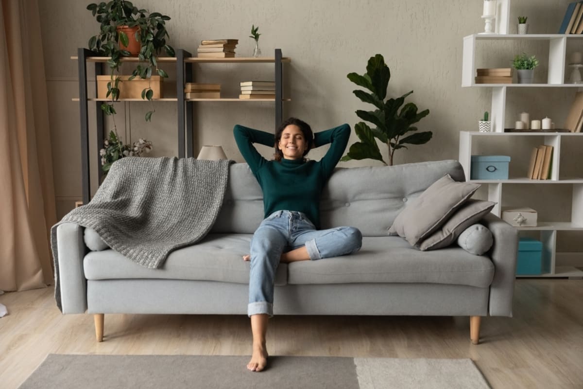 A happy tenant relaxing in their home, tenant retention strategies