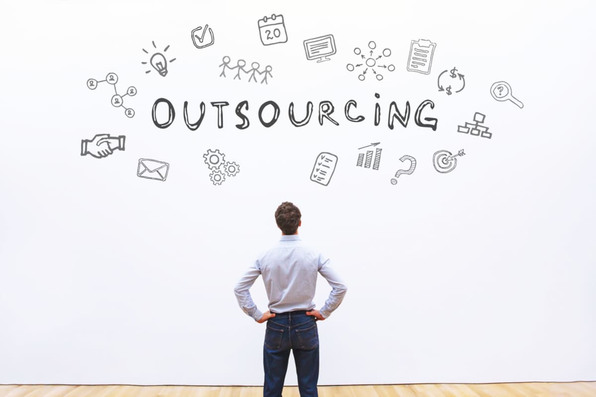 A man looking at the word outsourcing