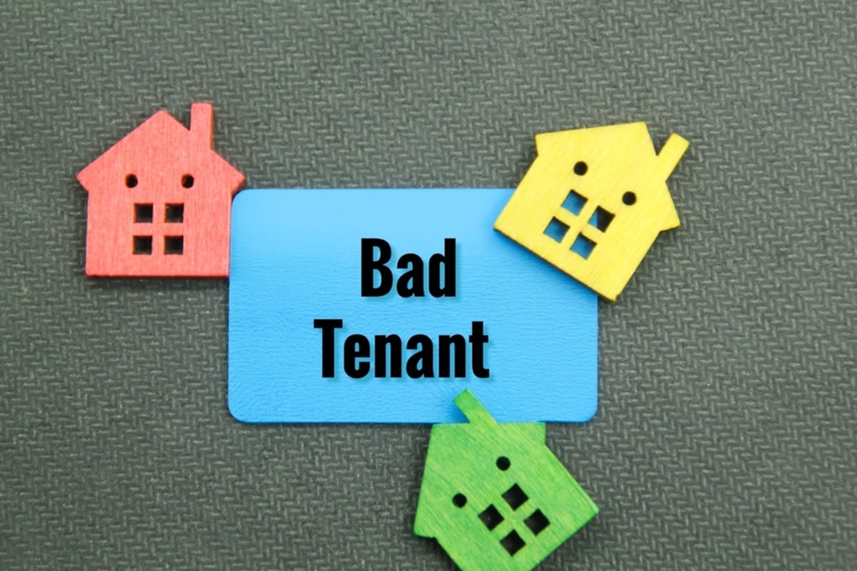 The word bad tenant with colorful houses around it
