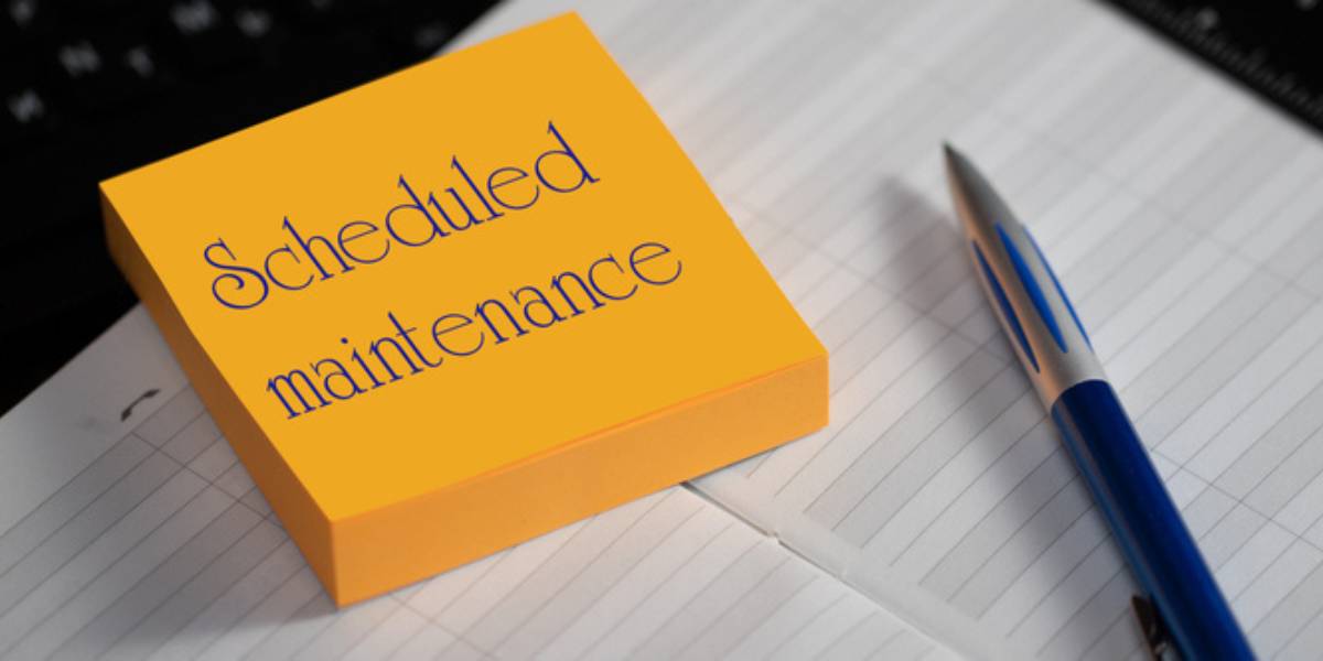 Close-up of a memory stick with the word scheduled maintenance