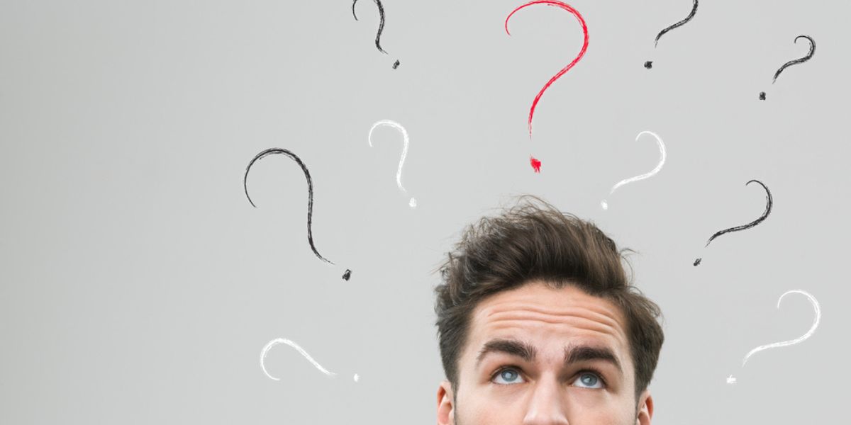 thinking man with many question marks above his head