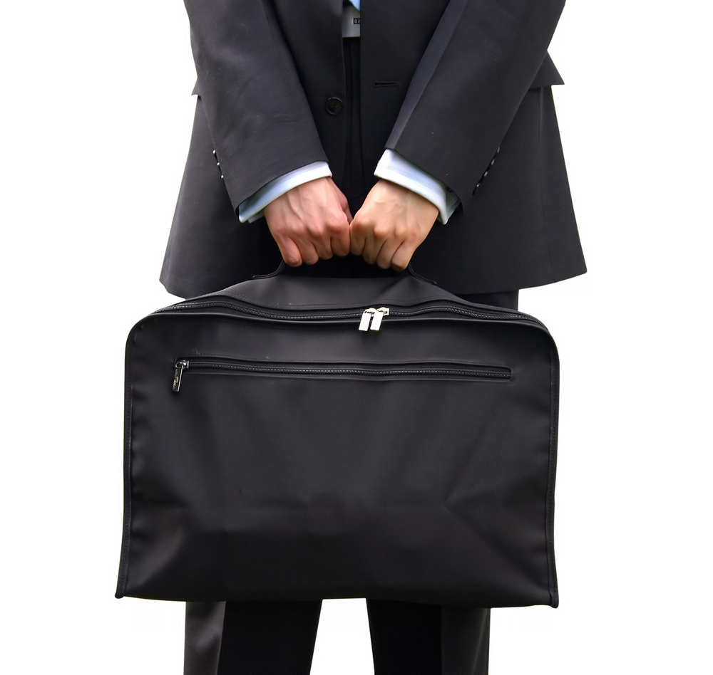business man holding a briefcase with both hands over a white background